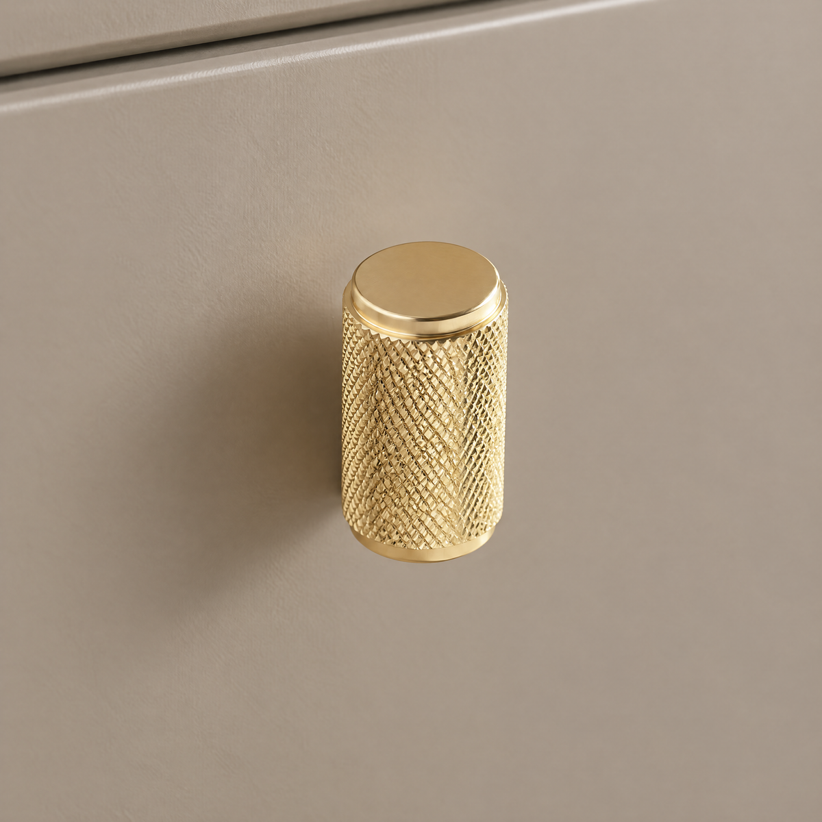 Langer gerändelter Zylinderknopf Ø 2 cm x 3,4 cm in Gold an taupefarbener Schublade
