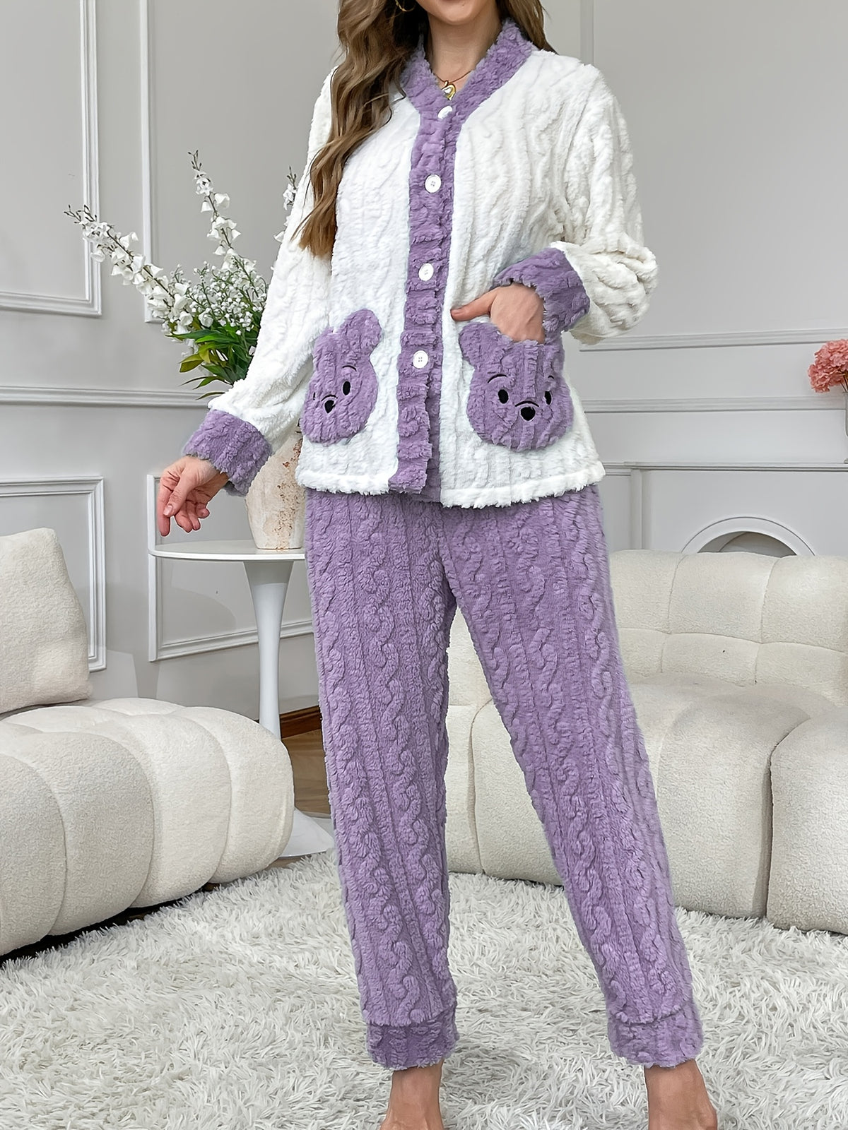 Flanell Pyjama Damen in Creme und Lila, Frau steht im Wohnzimmer, Hand in der Bärentasche