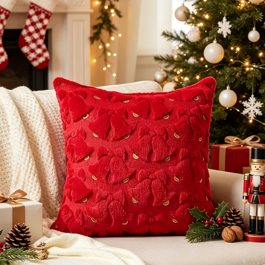 Rote Kissenhülle 45x45 mit 3D Glocken und goldenen Akzenten auf einem hellen Sofa