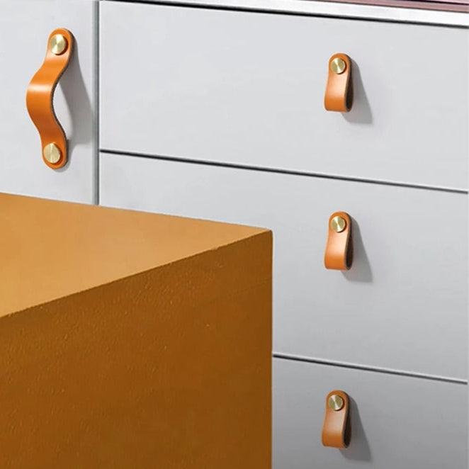 Einlochgriffe in Lederoptik in Hellorange an hellgrauen Schubladen